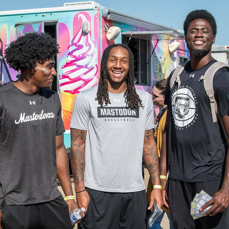 PFW students hanging near the food trucks at the Party at the Pitch event.
