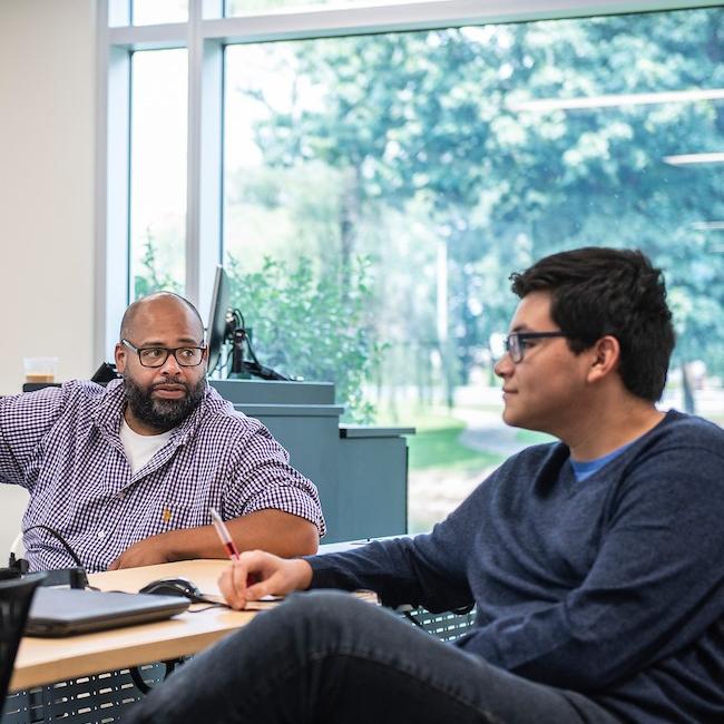 Two faculty members chatting in the IDEASpace during a CELT workshop.