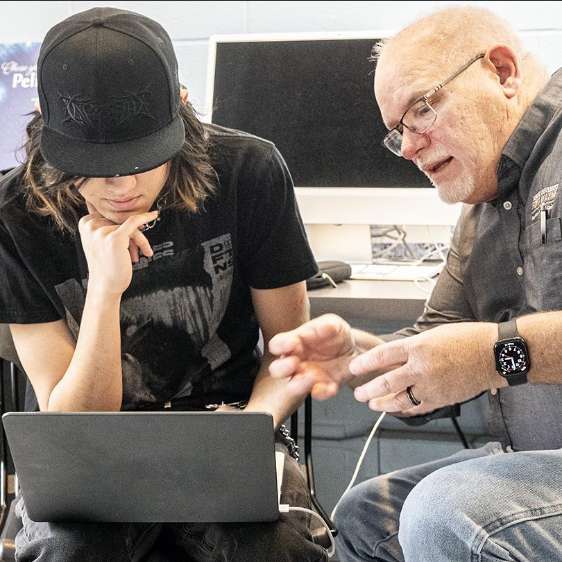 A student and professor collaborating in a classroom
