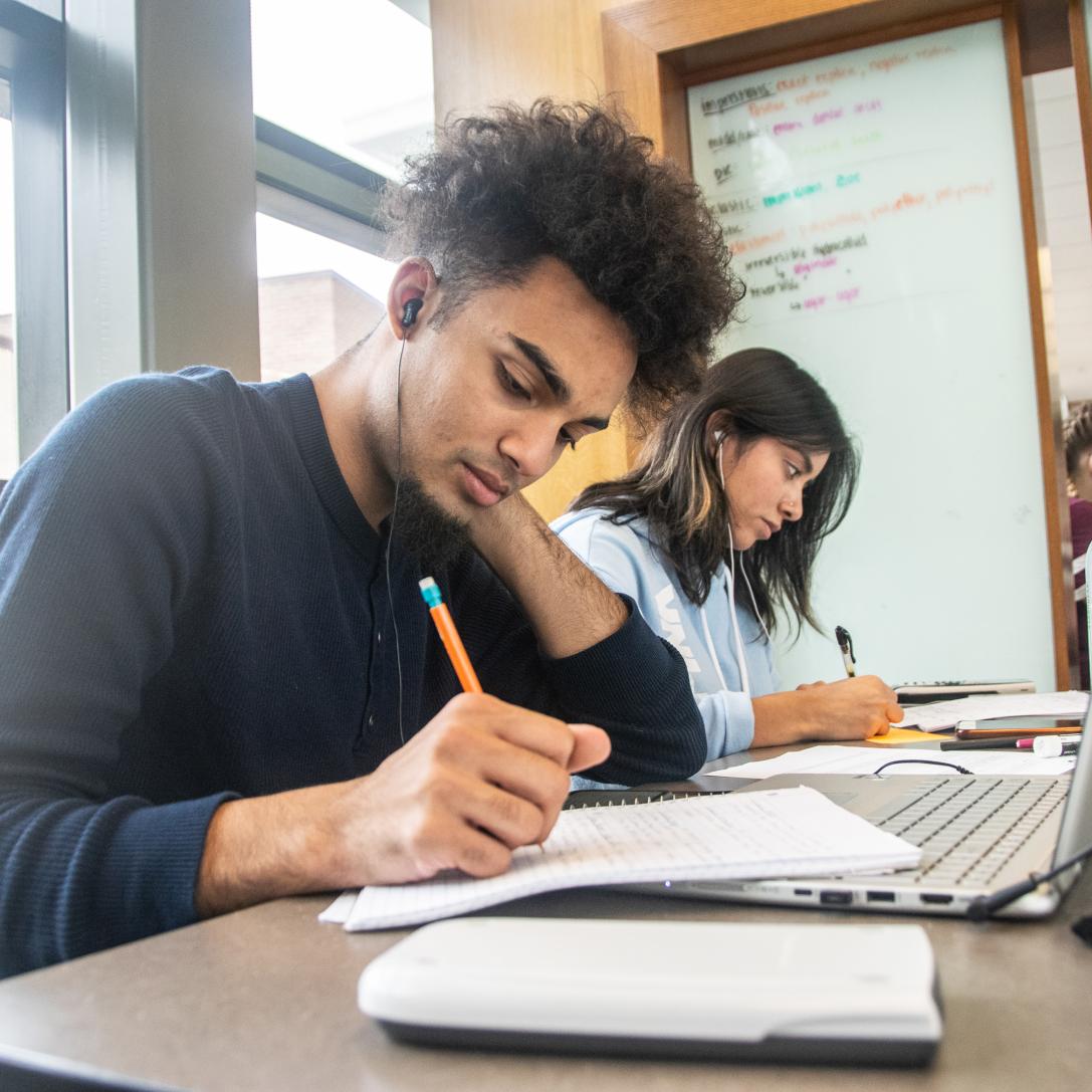 Student studying his class notes.
