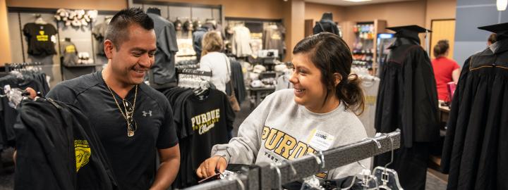 A new PFW student picks out clothing at the Mastodon Bookstore.