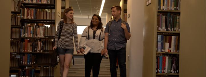 Students walking in the library.
