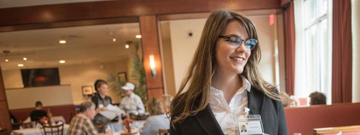Hospitality student helps customers.