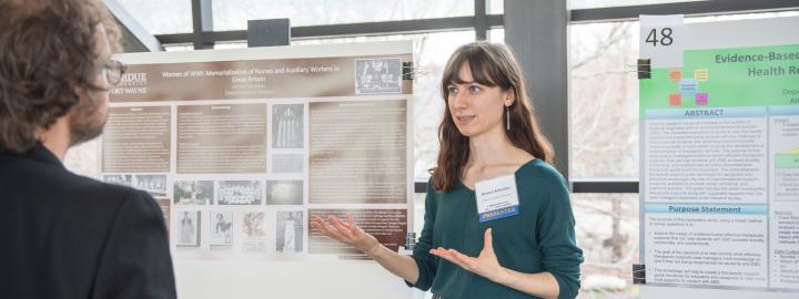 Student showing poster