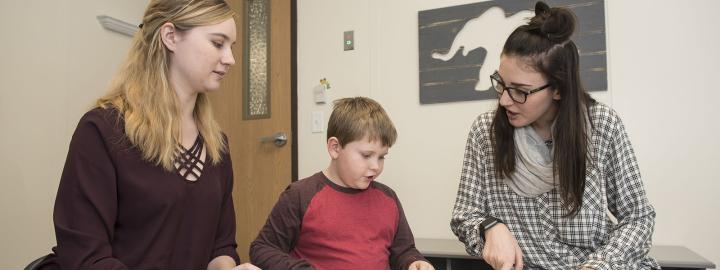 Students working with child