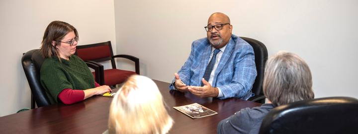 Staff speaking at a table