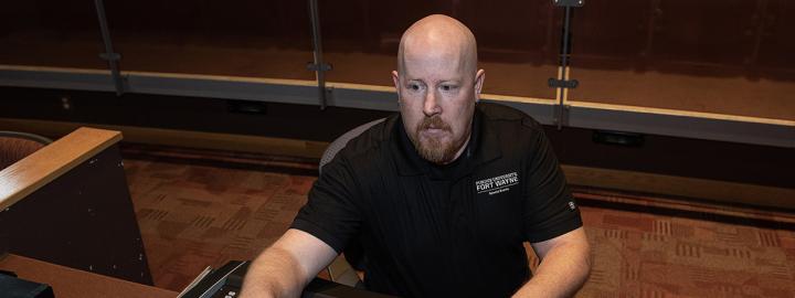 Tom Auer is working behind a sound board 