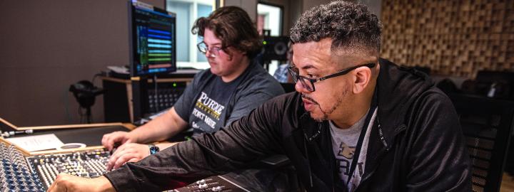 Two students working on music production in the Sweetwater center.