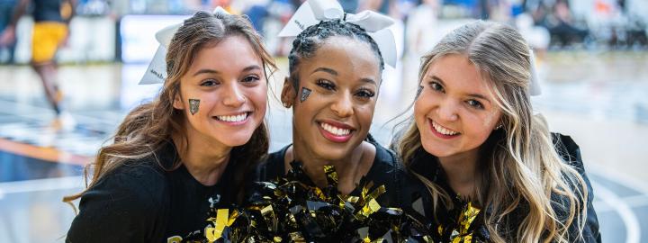 Three PFW cheerleaders are smiling