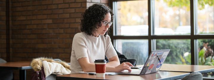 A student works on a laptop.