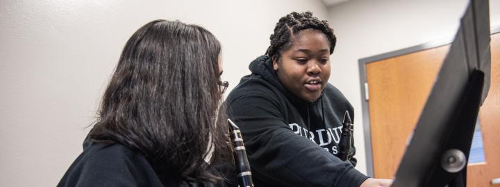 Music education major Jamia Green instructs a student during a clarinet lesson.