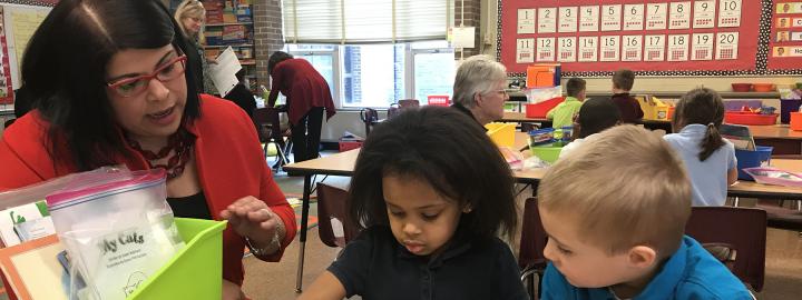 Maria Norman is working with elementary school students.