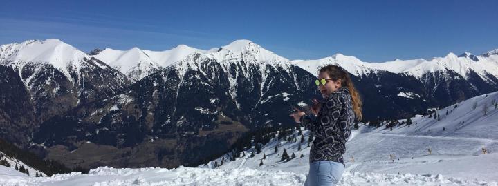 Student in the snow with mountain range in the background.