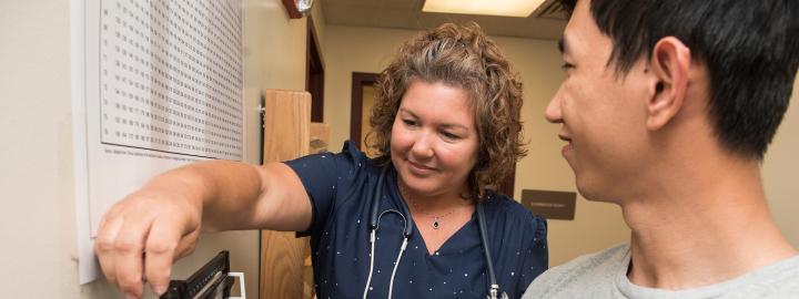 Nurse measuring the weight of a student