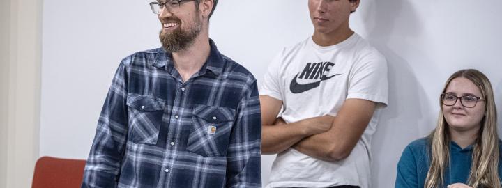 Students and professor standing in class