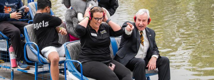 Chancellor riding a fan boat