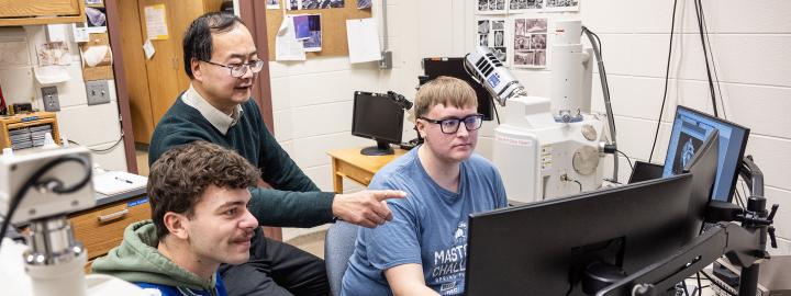 Professor and students using the scanning electron microscope