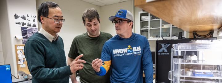 Professor and students discussing sample analysis