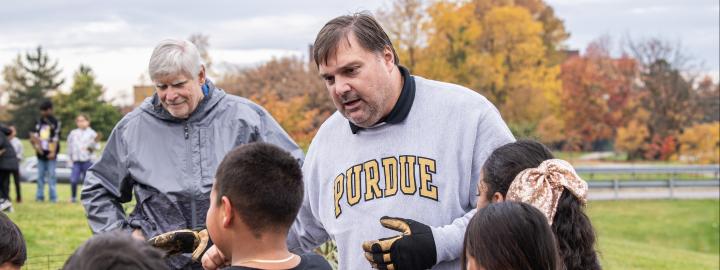 Young students working outdoors with instructor