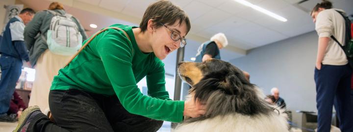 Student with a therapy dog.