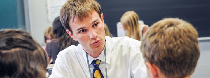 A male student teacher in the classroom