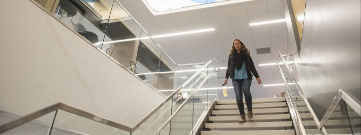 Helmke library where the student is descending the stairs from 2nd to 1st floor.
