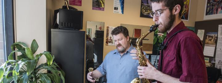 Professor teaching a saxophone student.