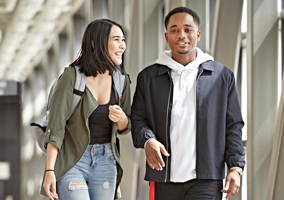 A couple walking in the student commons skybridge