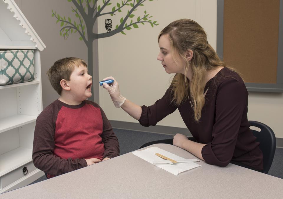 A CSD student works with a child
