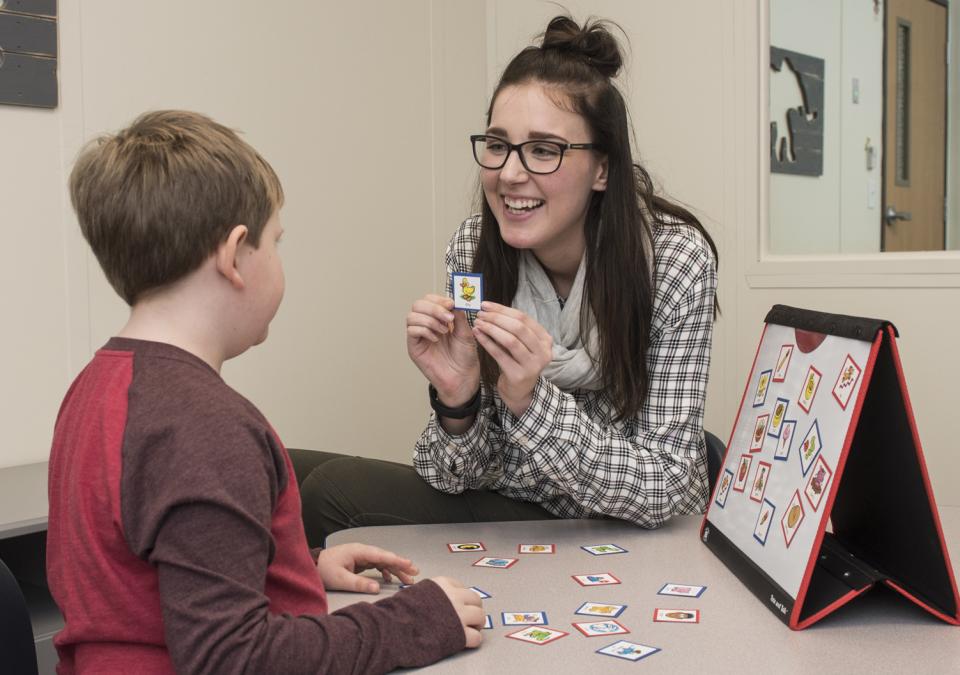 A CSD student works with a child