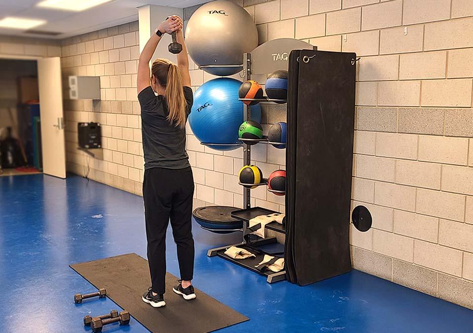 Helath Coach exercising with hand weights