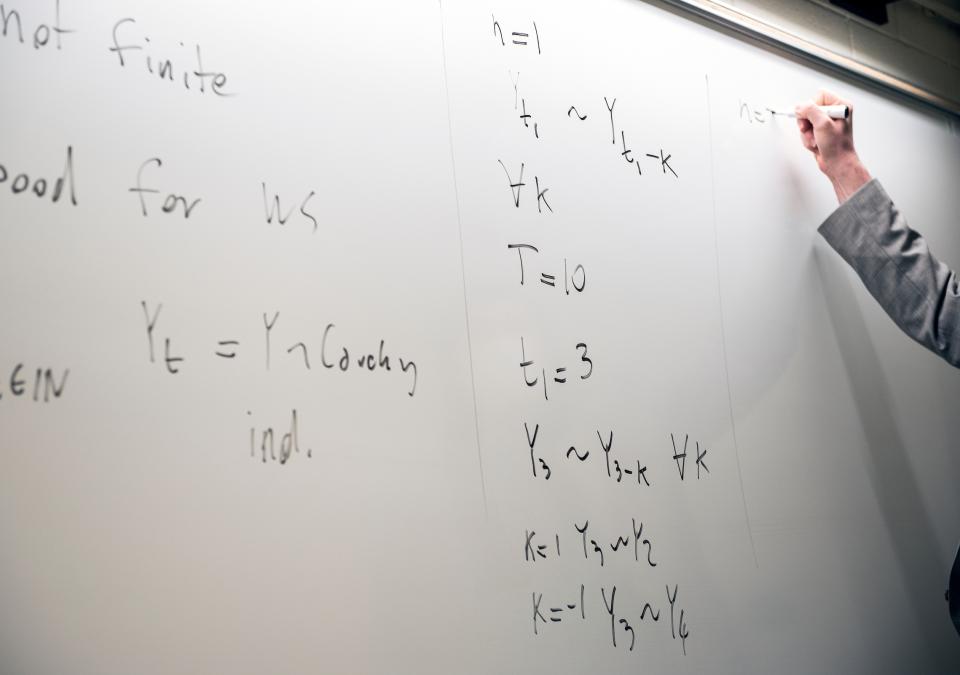 Whiteboard with math equations.