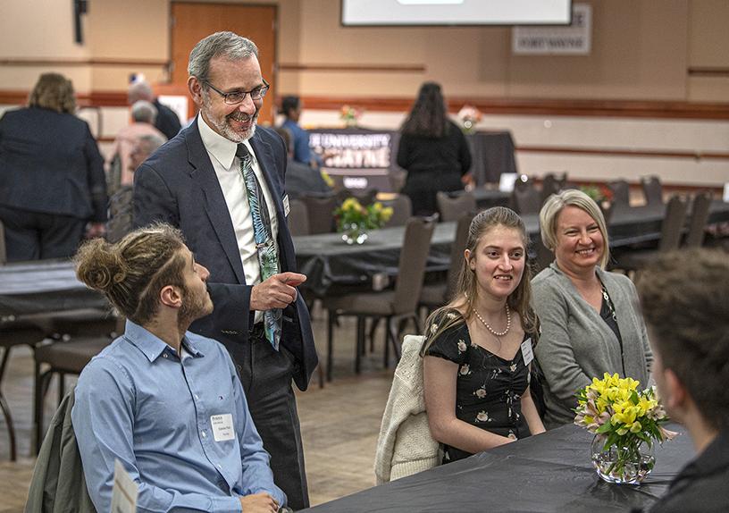 Ron Friedman visit with students and families at a student recognition event