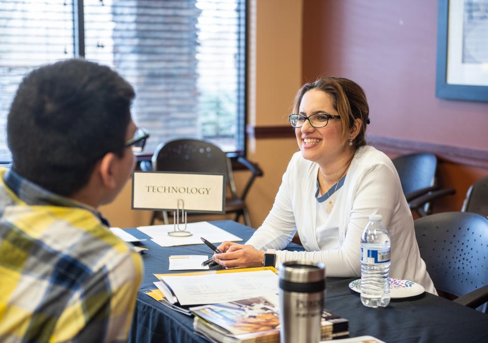 Behin Elahi chats with a potential student at a graduate studies open house