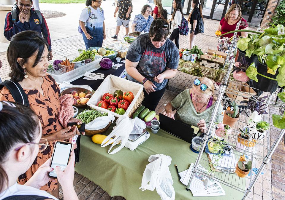 Vendors and wait on customers at the Plowshares Mobile Market