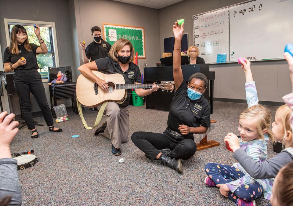Music therapy students work with young clients.