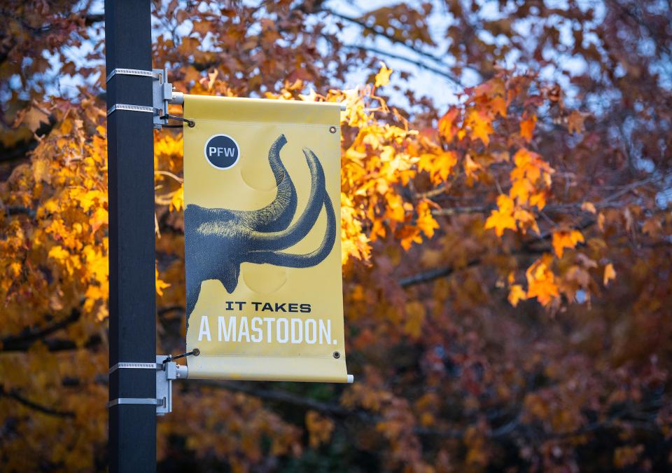 It takes a Mastodon pole banner with fall leaves in the background.