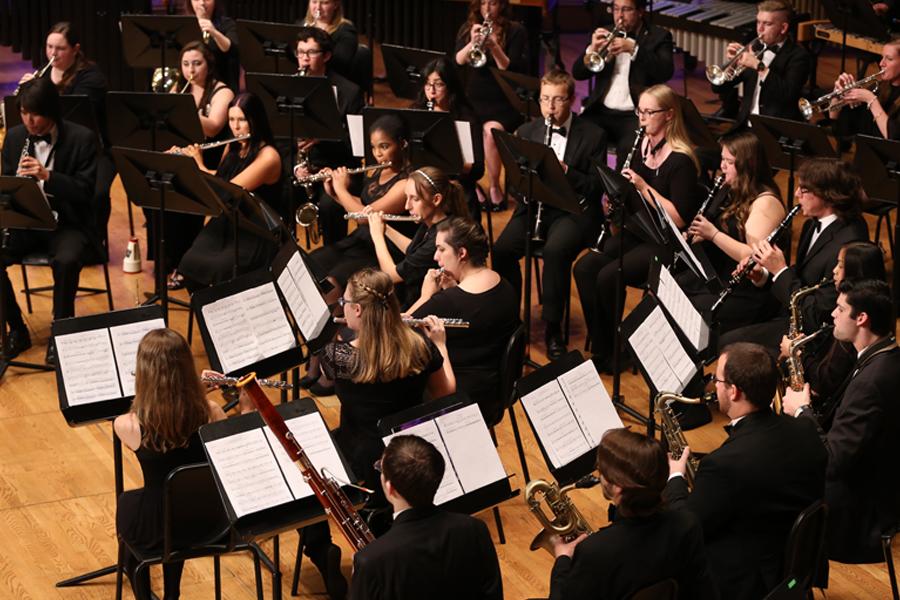 A group of students seated and playing instruments