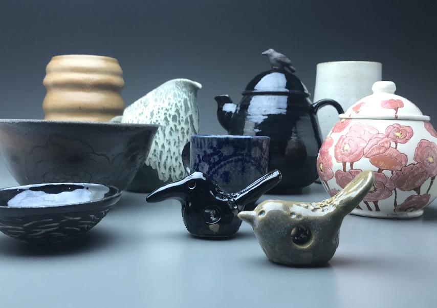 group of ceramic pieces on gradient background