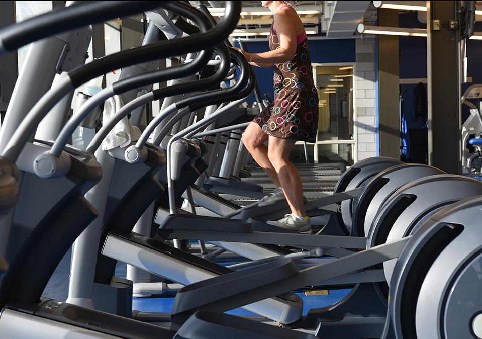 Person using the elliptical machine at the Fitness Center in Gates Center
