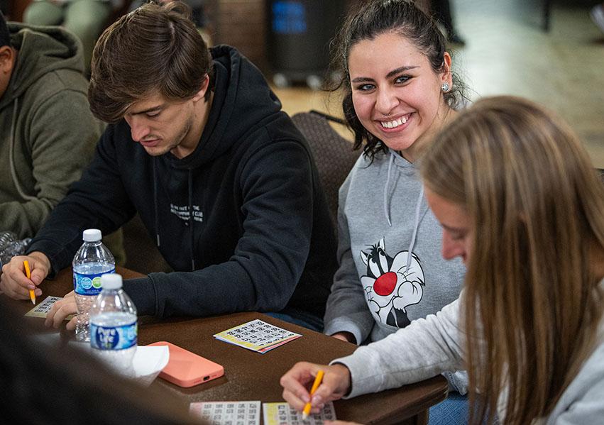 Smiling students at a bingo game