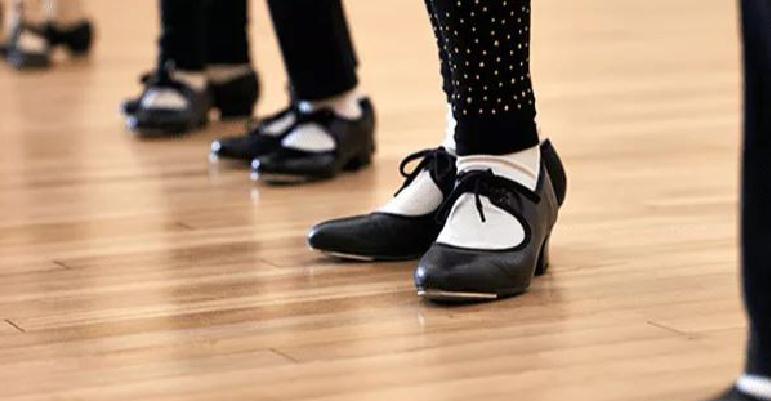Tap dancers shoes on wood floor.