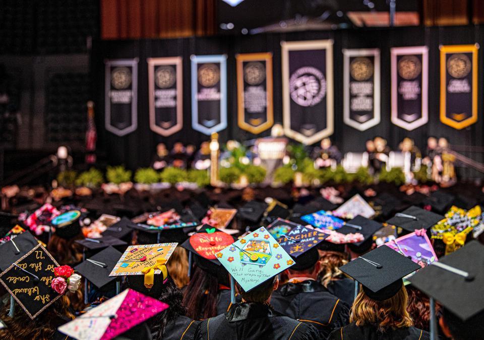 Students look toward the stage at commencement.