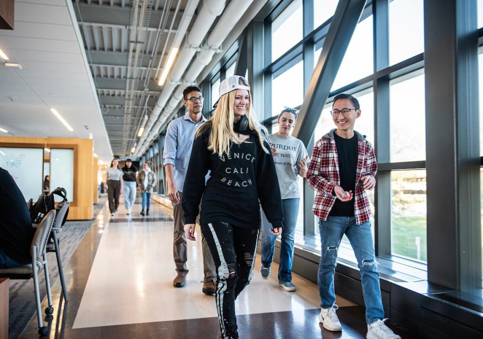 Students chat and walk across the Sky bridge.