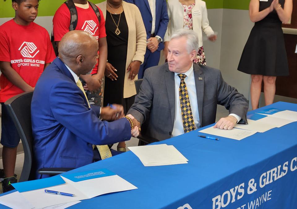 Joe Jordan and Ron Chancellor shake hands after signing the memorandum of understanding.