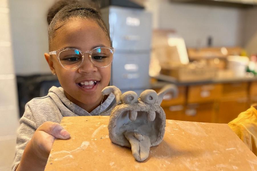 student with clay monster