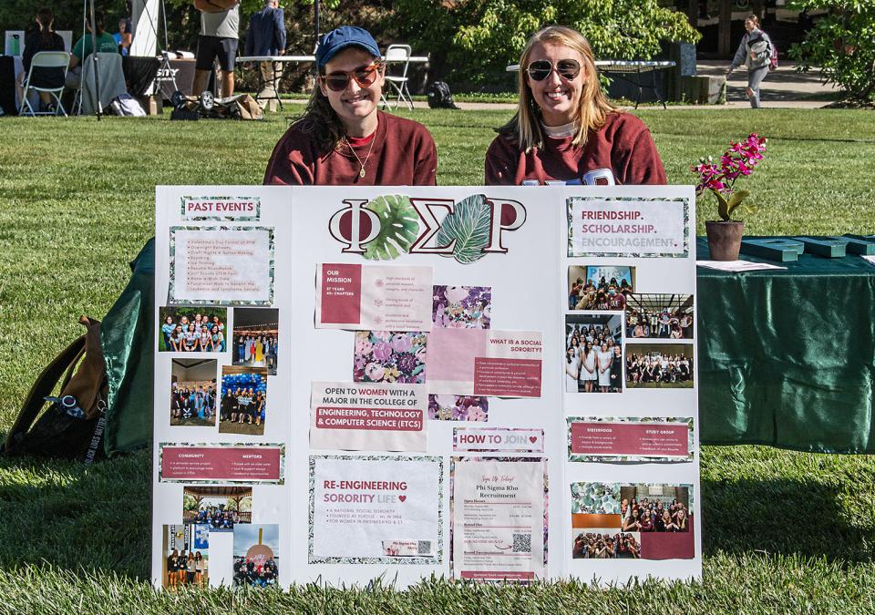 Two members of Phi Sigma Rho at the PFW connections fair