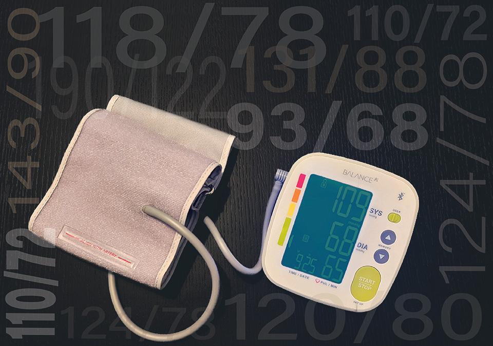 Blood pressure cuff and monitor with blood pressure numbers in the background