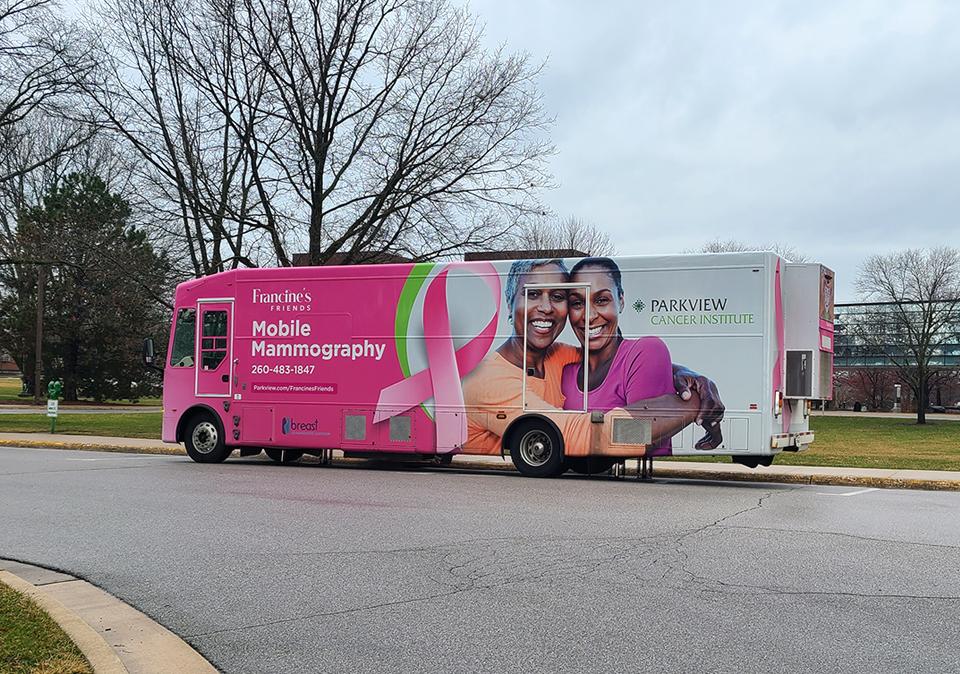 Photo of the pink and white Francine's Mobile Mammography Coach on Walb Circle Drive