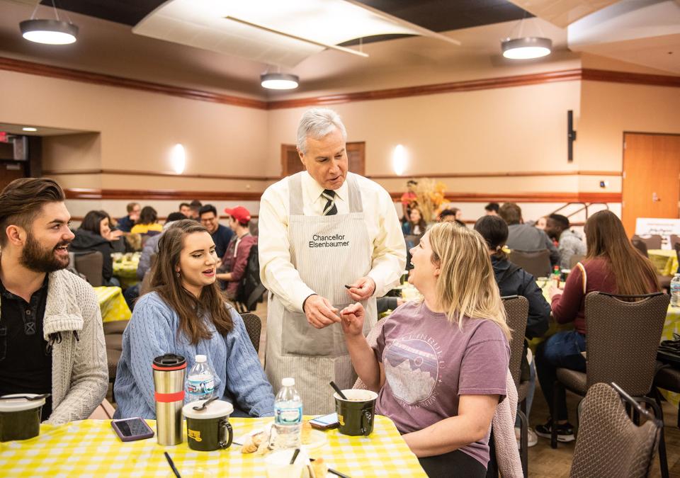 Chancellor Ron Elsenbaumer visits a table at Chili Fest.